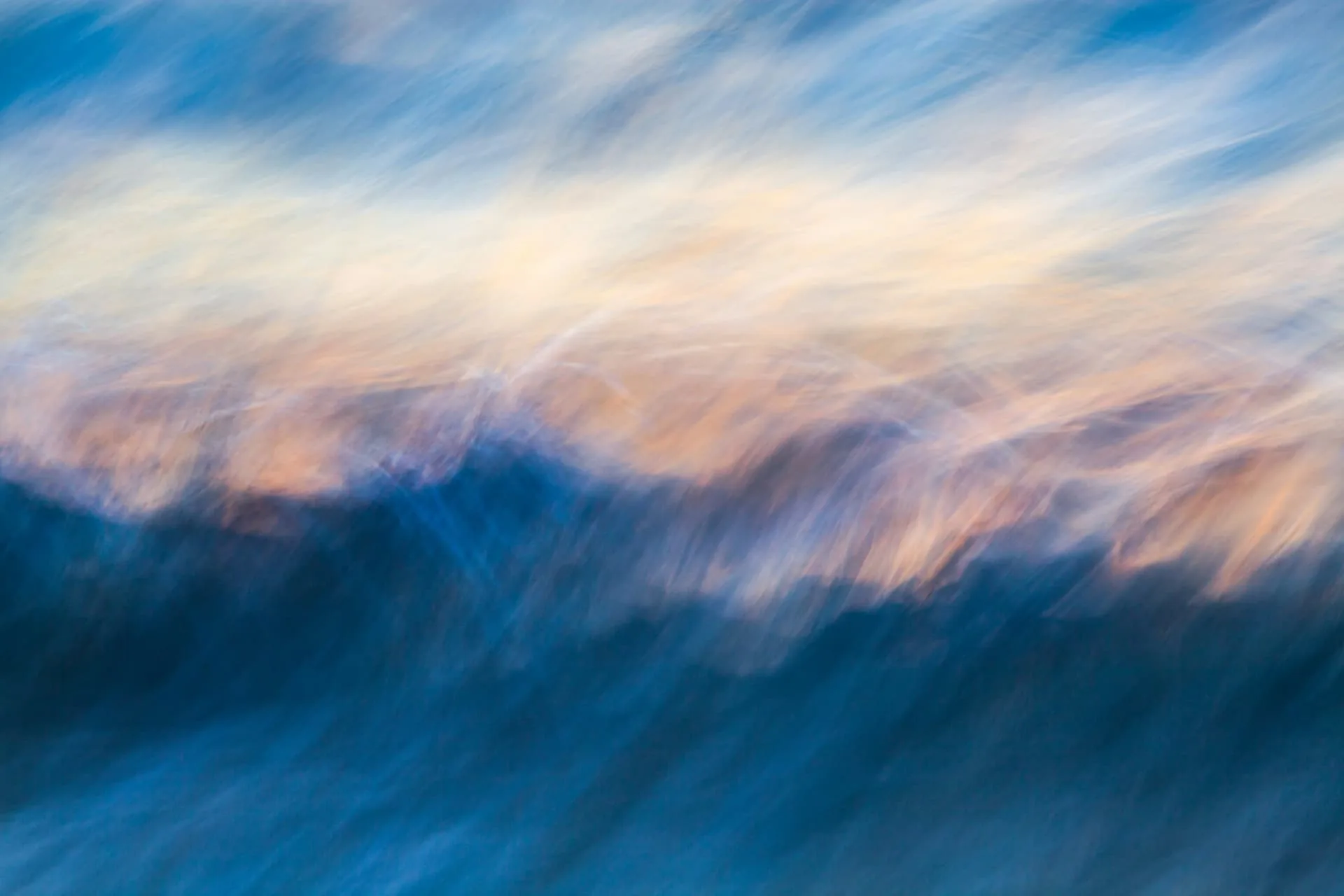 Abstract blue and amber sky in soft motion at sunset
